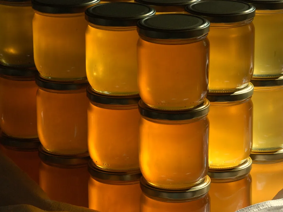 Filled jars in rows, waiting to be labelled.